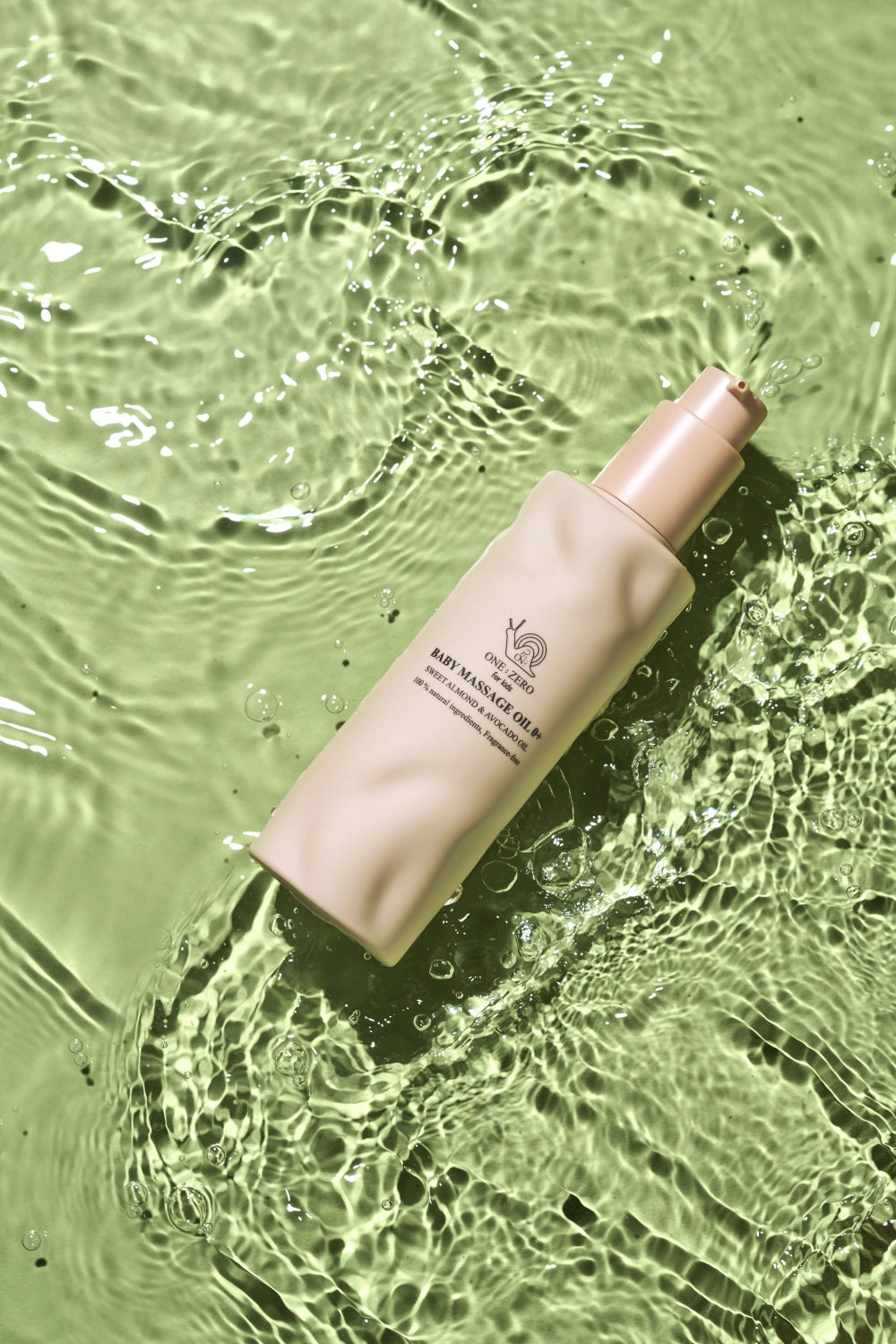 A bottle of baby massage oil on greenish water