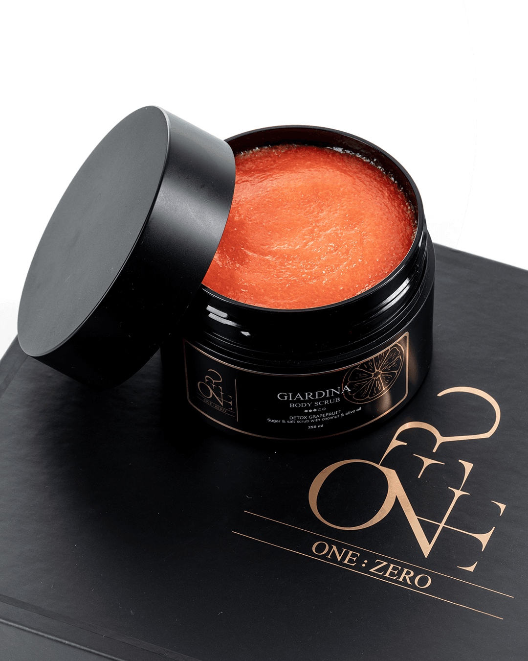 An open jar with orange "Giardina" body scrub texture